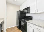 Thumbnail 25 of 27 - Brookstone Unit Kitchen at Bookstone and Terrace Apartments in Irving, Texas