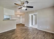 Thumbnail 17 of 27 - Living Area with Ceiling Fan at Bookstone and Terrace Apartments in Irving, Texas