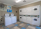 Thumbnail 36 of 37 - A row of washers and dryers at our onsite laundry facility at The Oasis apartments in Bossier City, LA