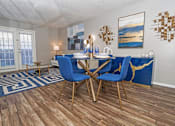 Thumbnail 6 of 37 - Dining area in the model unit with table and chairs next to living room at The Oasis apartments in Bossier City, LA