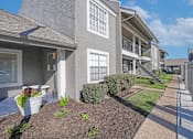 Thumbnail 32 of 37 - A grey building with a white door and windows at The Oasis apartments in Bossier City, LA