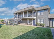 Thumbnail 33 of 37 - A two-story building with stairway up to units at The Oasis apartments in Bossier City, LA