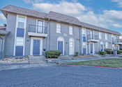 Thumbnail 28 of 37 - Row of our townhouse floorplans with blue doors and white trim at The Oasis apartments in Bossier City, LA