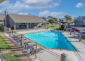 Thumbnail 24 of 37 - Large swimming pool surrounded by a fence behind the leasing office at The Oasis apartments in Bossier City, LA.