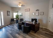 Thumbnail 8 of 25 - A reception area with a desk and chairs.