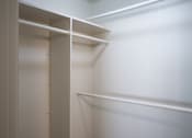 Thumbnail 20 of 25 - A white closet with shelves and a door.