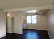 Thumbnail 21 of 25 - A room with a ceiling fan and a window with blinds.