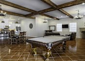 Thumbnail 6 of 18 - a game room with a pool table and a fireplace