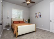 Thumbnail 10 of 18 - a bedroom with a bed and a ceiling fan