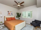Thumbnail 13 of 13 - a bedroom with a bed and a ceiling fan