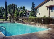 Thumbnail 13 of 32 - a pool with a fence around it and a house in the background