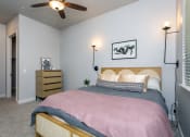 Thumbnail 11 of 18 - a bedroom with a bed and a ceiling fan