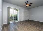 Thumbnail 5 of 18 - an empty living room with a ceiling fan