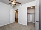 Thumbnail 12 of 18 - a bedroom with a ceiling fan and closet