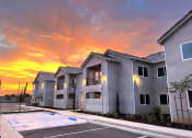 Thumbnail 2 of 13 - Exterior Apartment Building with Sunset
