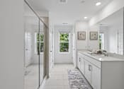 Thumbnail 8 of 49 - A white kitchen with a large mirror on the wall.