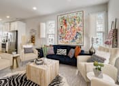 Thumbnail 4 of 12 - A living room with a large tapestry on the wall and a zebra print rug on the floor.