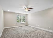 Thumbnail 9 of 24 - A room with a ceiling fan and a window with blinds.