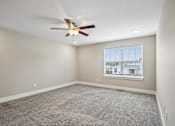 Thumbnail 10 of 24 - A room with a ceiling fan and a window with blinds.