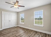 Thumbnail 12 of 24 - A room with a ceiling fan and a window with blinds.
