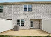Thumbnail 18 of 24 - A brick house with a white garage door.