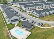 Thumbnail 20 of 24 - A large swimming pool is surrounded by a small pavilion and a grassy area.