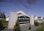Thumbnail 24 of 24 - A sign that says South Maple Townhomes stands in front of a grassy area.