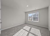 Thumbnail 10 of 29 - A room with a carpet floor and a window with blinds.