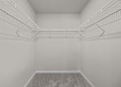 Thumbnail 24 of 29 - A white empty room with a carpeted floor and a metal rack on the wall.