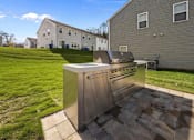 Thumbnail 27 of 29 - A modern outdoor kitchen with a grill and sink.