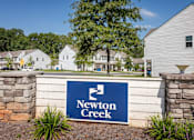 Thumbnail 29 of 29 - A sign that says Newton Creek in front of some houses.