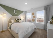 Thumbnail 41 of 49 - A bedroom with a large bed and a green crescent moon on the wall.