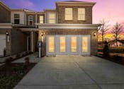 Thumbnail 49 of 49 - A modern house with a large front yard and a driveway.