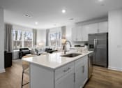 Thumbnail 20 of 49 - A modern kitchen with a large island and stainless steel appliances.