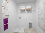 Thumbnail 39 of 49 - A bathroom with a toilet, a sink, and a towel rack.