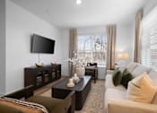 Thumbnail 29 of 49 - A modern living room with a flat screen TV mounted on the wall.