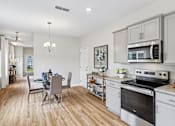 Thumbnail 4 of 16 - A kitchen with a dining table and chairs.