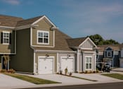 Thumbnail 1 of 16 - A row of houses with garages on the side.