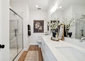 Thumbnail 12 of 13 - A bathroom with a white sink and a brown rug.