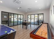 Thumbnail 12 of 46 - A room with a pool table and air conditioning unit.