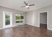 Thumbnail 4 of 50 - an empty living room with a ceiling fan and a window