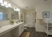 Thumbnail 5 of 11 - A bathroom with a white counter and a white toilet.