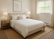 Thumbnail 7 of 11 - A bedroom with a large bed and two lamps.