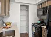 Thumbnail 4 of 20 - Kitchen with walk in pantry and stainless appliances at Skyline at Barton Creek Apartments, Austin, 78758