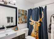 Thumbnail 8 of 20 - Bathroom with modern vanity and artistic shower curtain at Skyline at Barton Creek Apartments, Austin, Texas