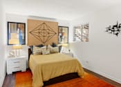 Thumbnail 7 of 20 - Bedroom with gold bedding and geometric wall art at Skyline at Barton Creek Apartments, Austin