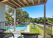 Thumbnail 2 of 20 - Private balcony overlooking pool and playground at Skyline at Barton Creek Apartments, Texas