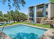 Thumbnail 17 of 20 - Swimming pool with lounge chairs and building views at Skyline at Barton Creek Apartments, Texas, 78758