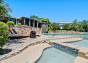 Thumbnail 18 of 20 - Multi level pool area with stone accents at Skyline at Barton Creek Apartments, Austin, TX 78758