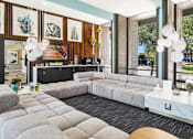 Thumbnail 10 of 20 - Clubhouse lounge with tufted seating and pendant lighting at Skyline at Barton Creek Apartments, Austin, TX